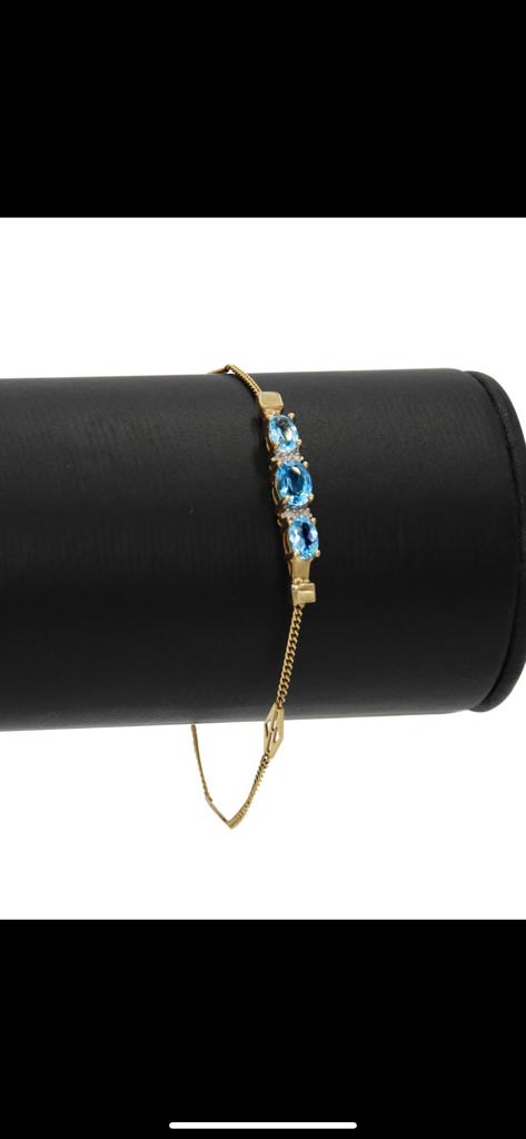 Fancy 14 karat gold blue topaz and diamond bracelet