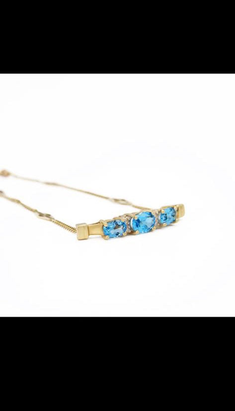 Fancy 14 karat gold blue topaz and diamond bracelet